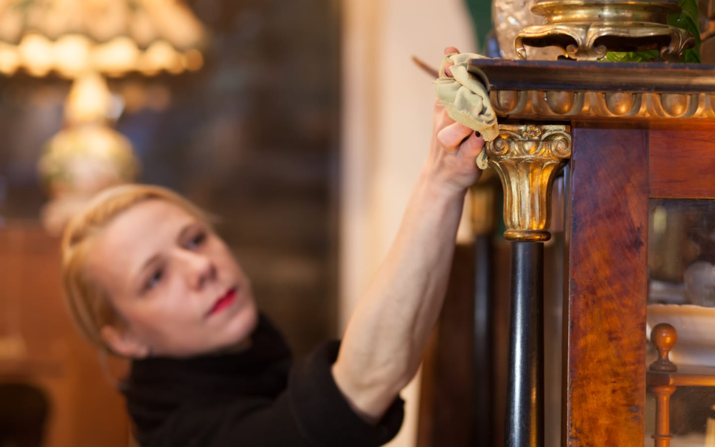 سيدة تنظف إطار لوحة خشبي