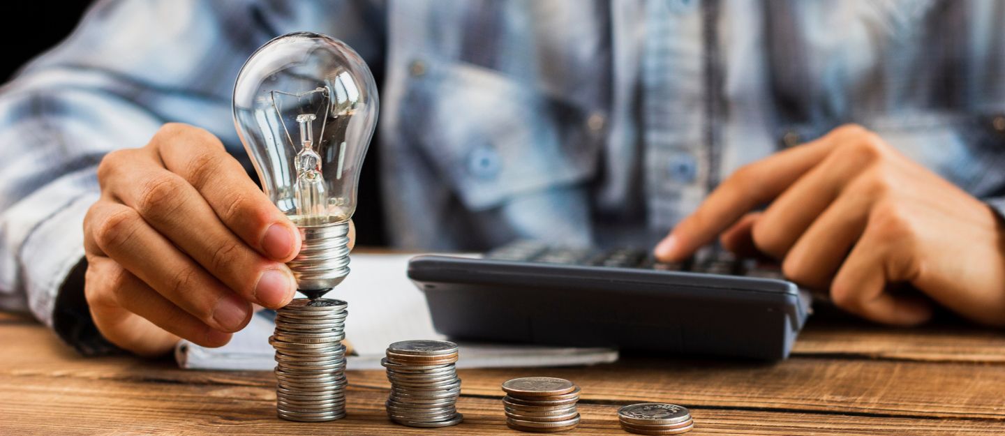 A man holding electric bulb - pay dewa bills in dubai