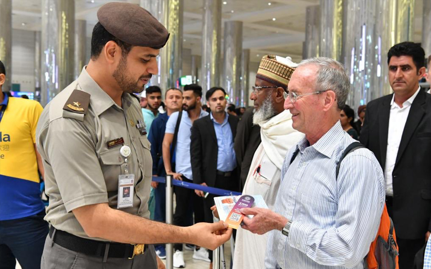 Travellers in DXB airport getting free Expo 2020 bookmarks