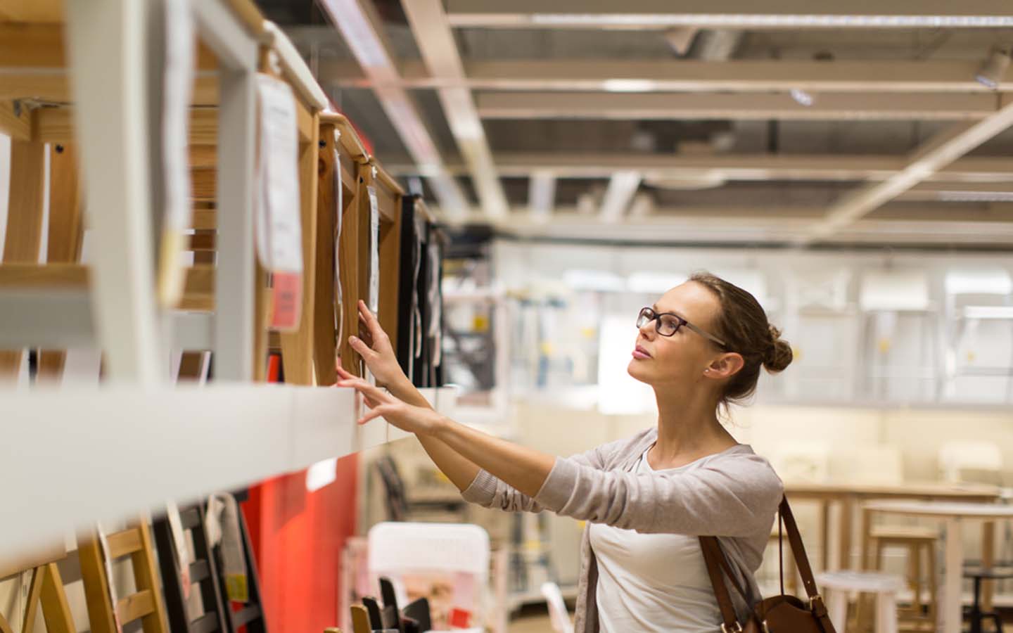 A woman picking cabinets for kitchen at a furniture store
