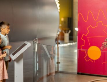 kids exploring robot section in museum