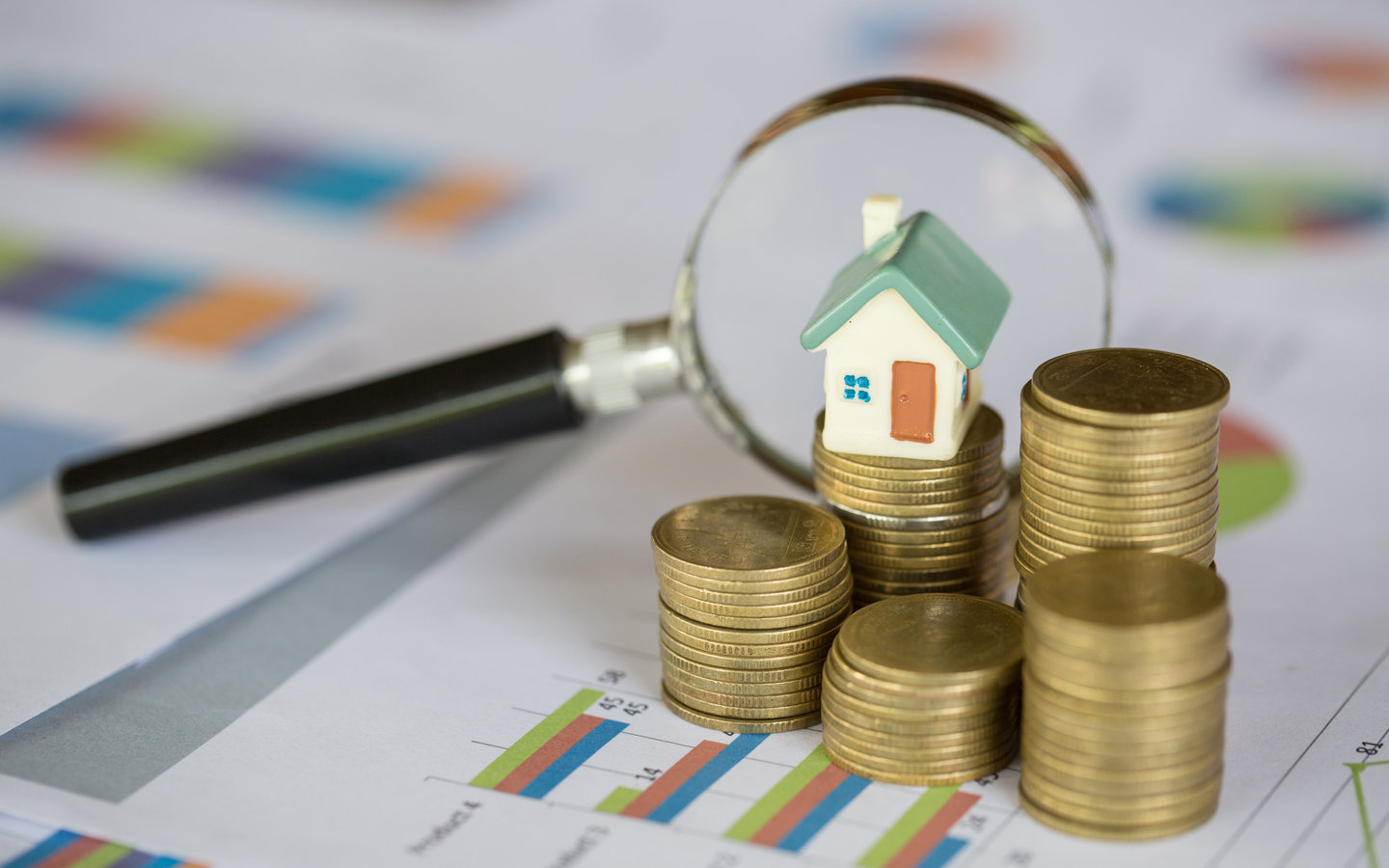 نقود معدنية مع مجسم منزل