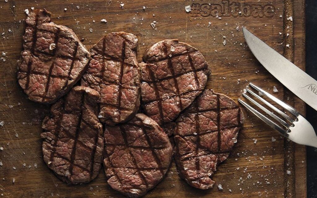 Savour signature cuts like rib-eye and tenderloin at the iconic Nusr-Et Steakhouse in Dubai