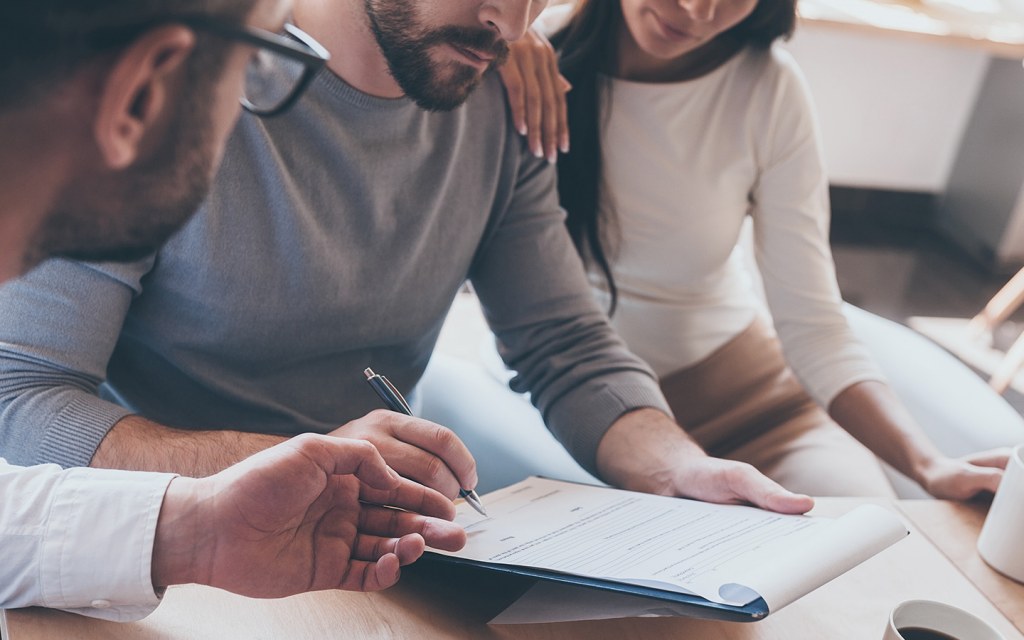 couple signing property insurance UAE