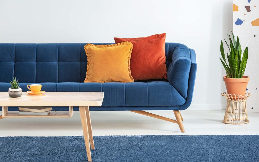 midnight blue sofa with a coffee table in living room