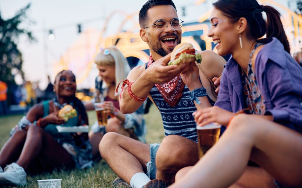 People enjoying food on the ground