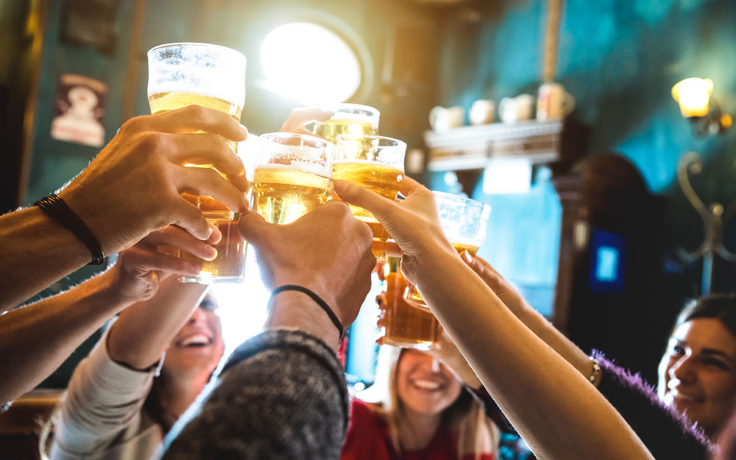 friends at a pub toasting beer