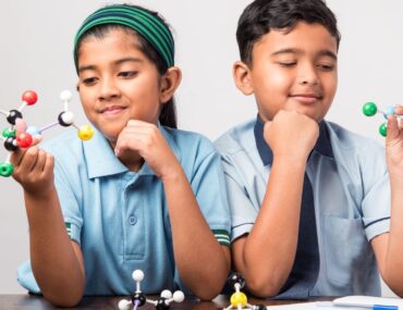 students performing science activity at one of the best indian schools in Sharjah