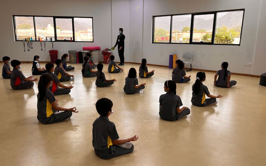 students performing yoga